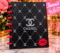 Black patterned notebook front with pink binding