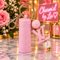 Light pink lip balm holder keychain with gold-tone hardware and decorative charms